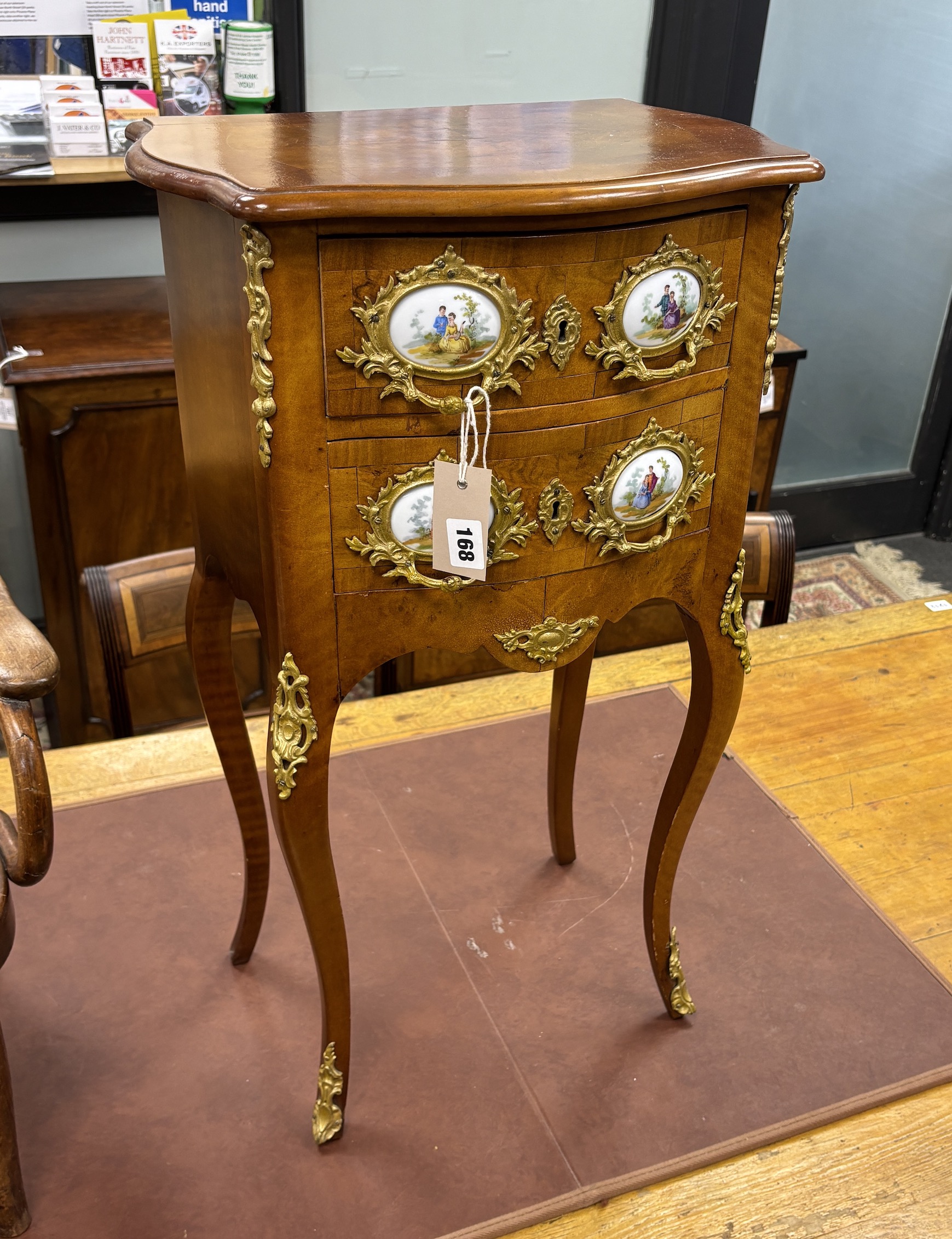 A Louis XVI style gilt metal and porcelain mounted small serpentine two drawer chest, width 41cm, depth 28cm, height 71cm